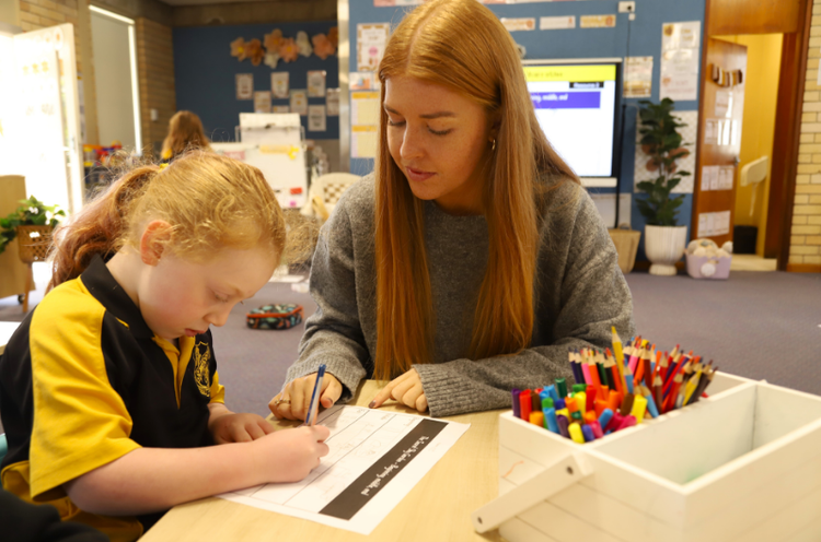 Miss Preston helping a student with their work