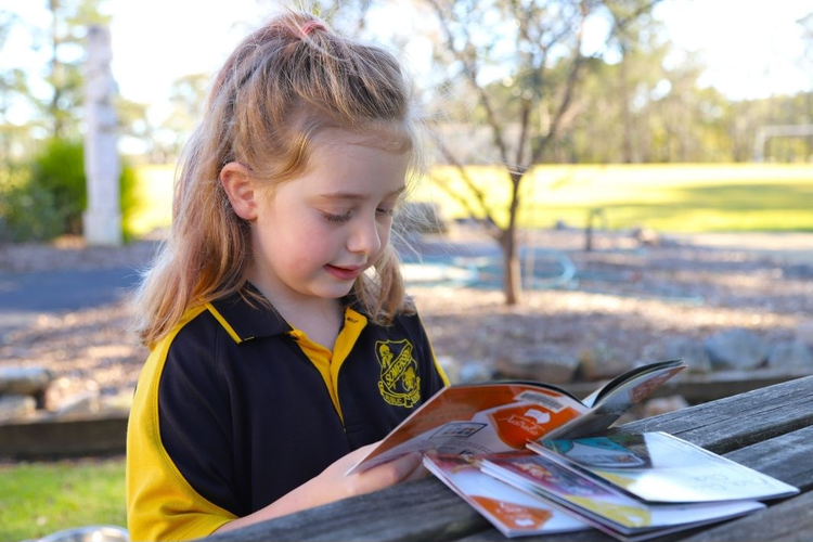 a female student reading a decodable book